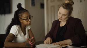 Photo of Adrieanna Hutson and client (Yolanda Muldrow) discussing their case